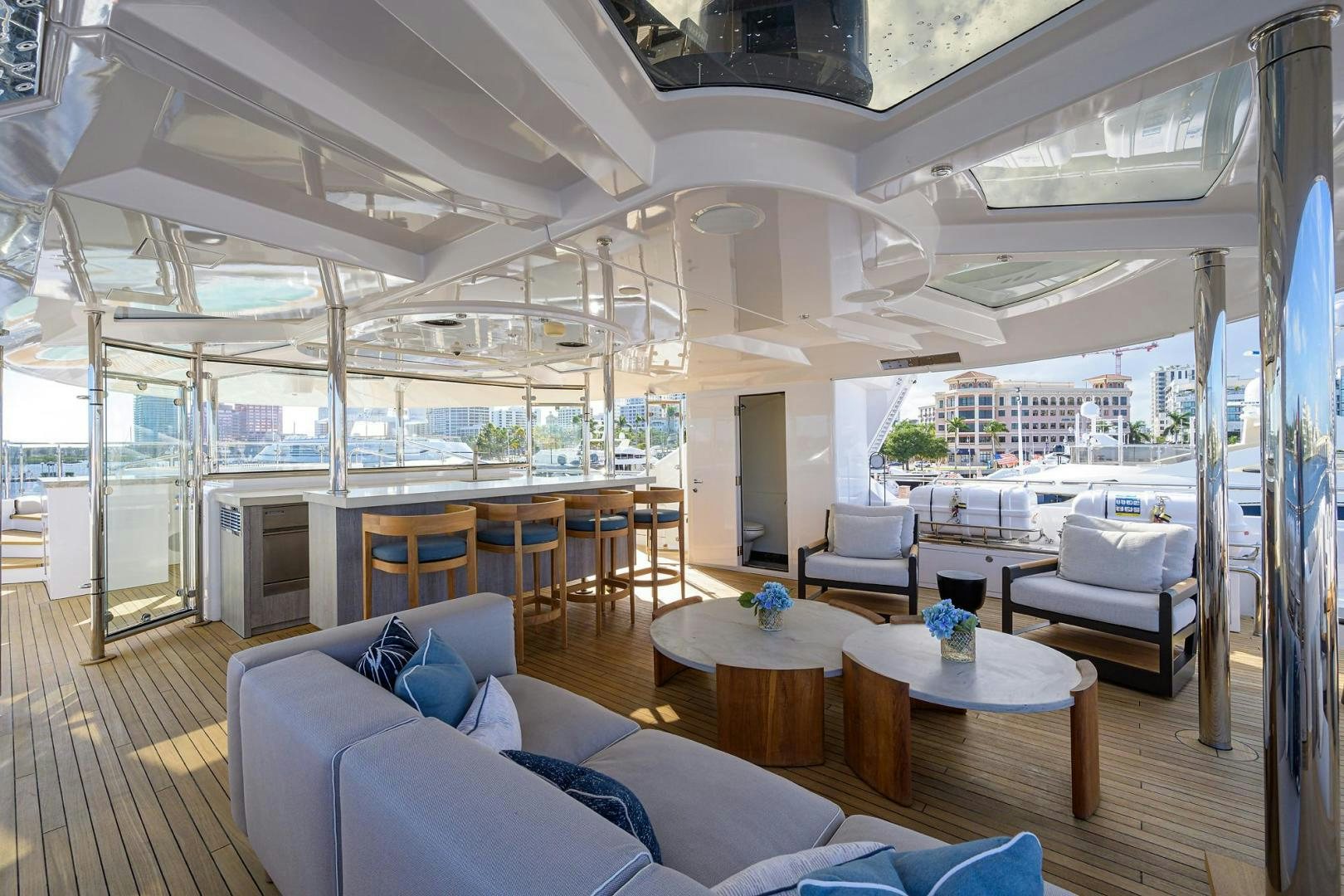 a room with a table chairs and a view of a city aboard SEANASH Yacht for Sale
