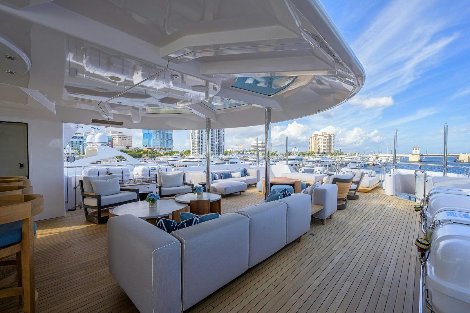 a large room with a large lounge area and a large city landscape aboard SEANASH Yacht for Sale