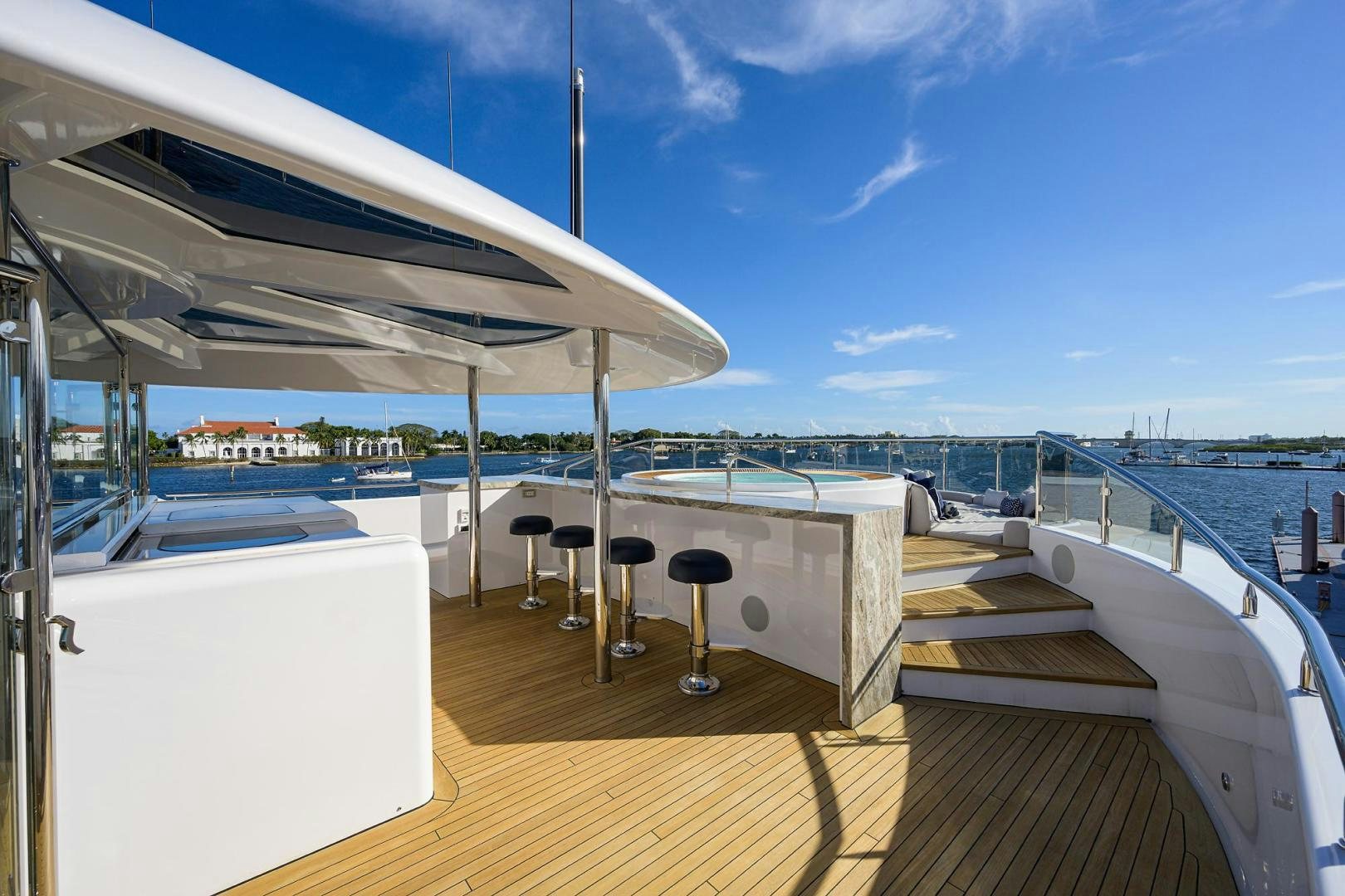 a deck with a table and chairs on it aboard SEANASH Yacht for Sale