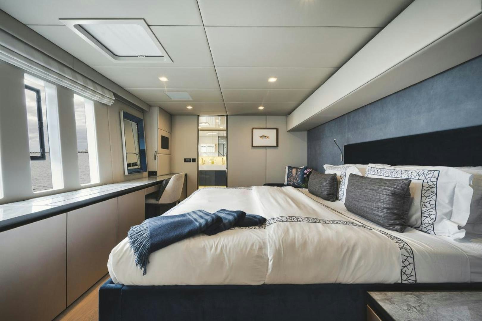 a bedroom with a bed and a chair aboard SANDY II Yacht for Sale