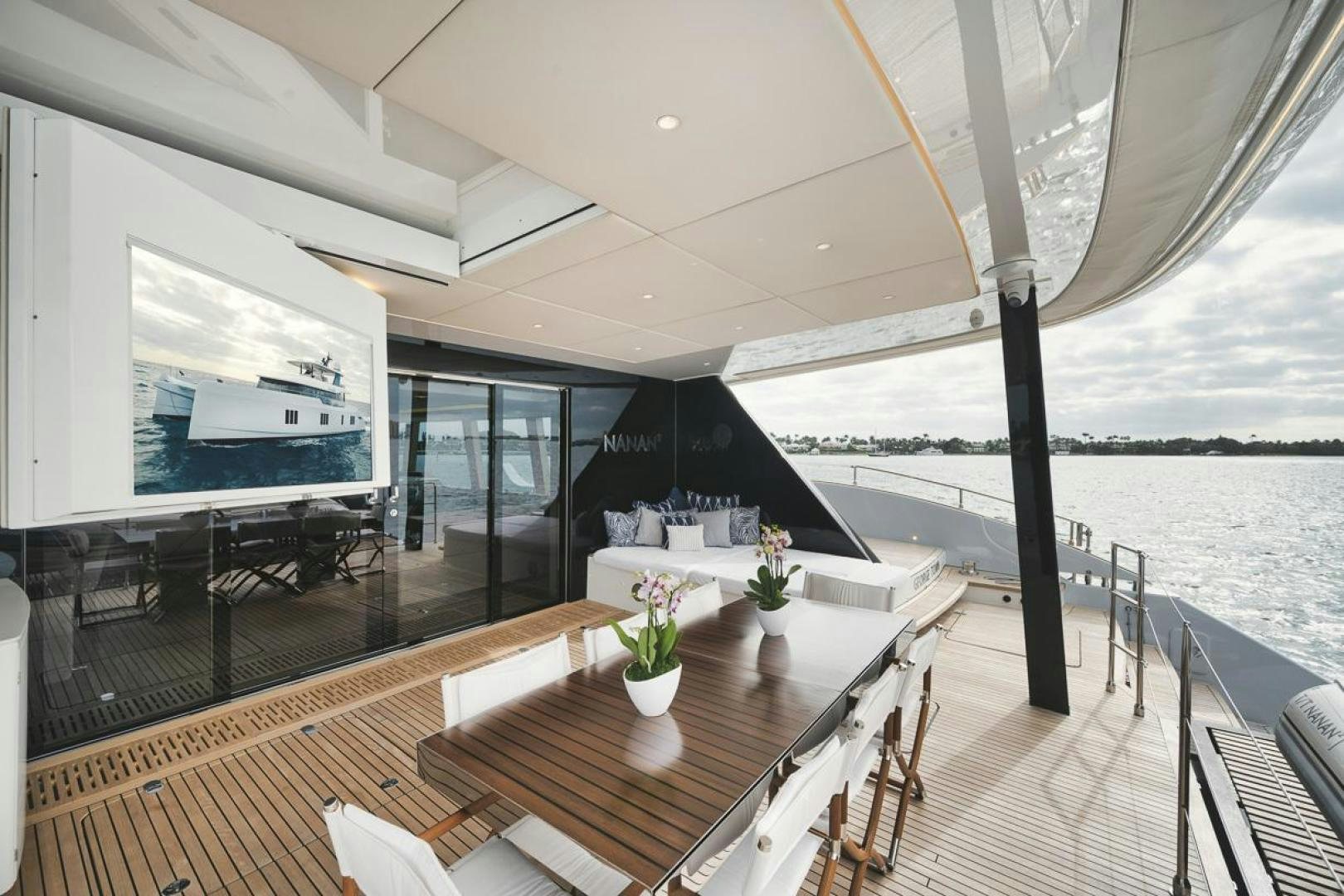 a balcony with a table and chairs aboard SANDY II Yacht for Sale