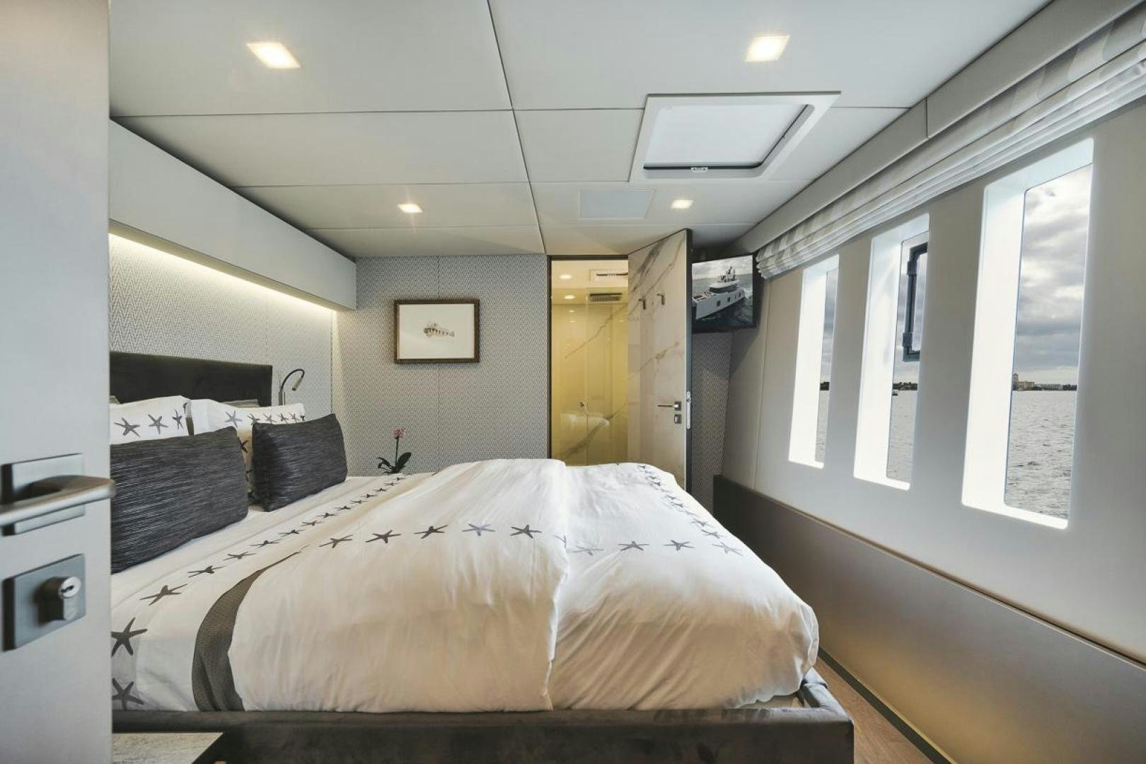 a bedroom with a bed and a window aboard SANDY II Yacht for Sale