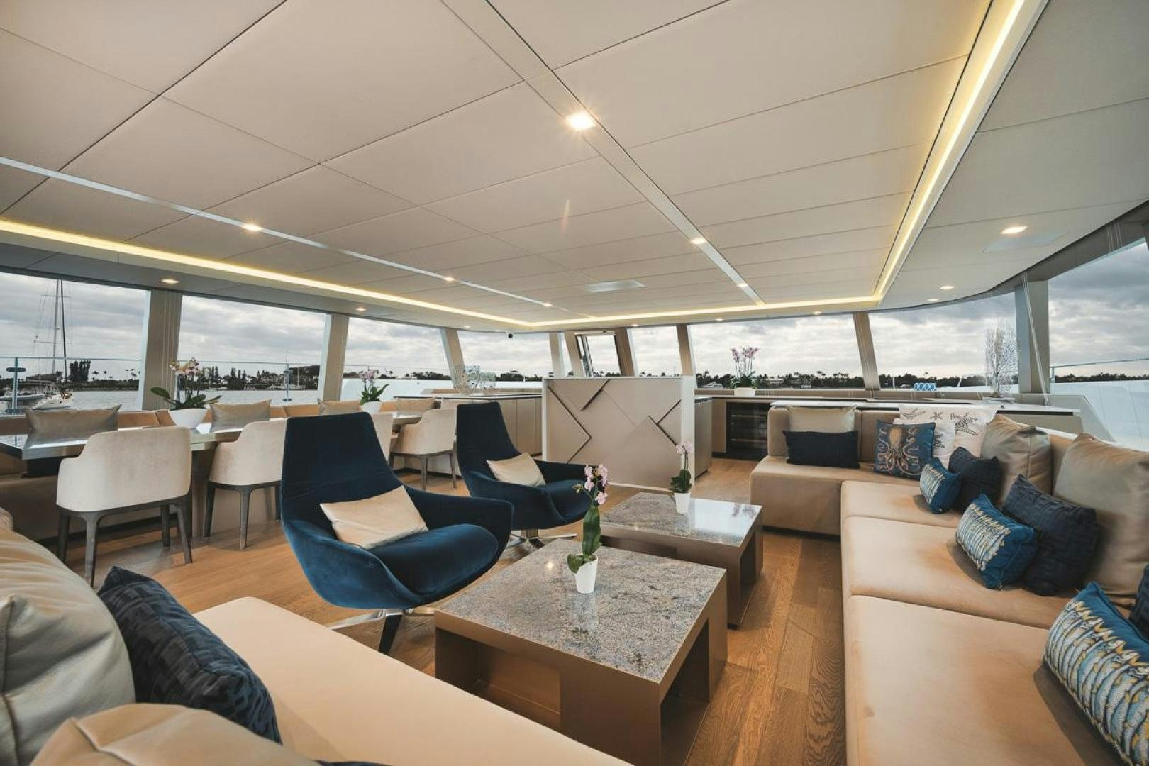 a room with a couch and a table and chairs aboard SANDY II Yacht for Sale