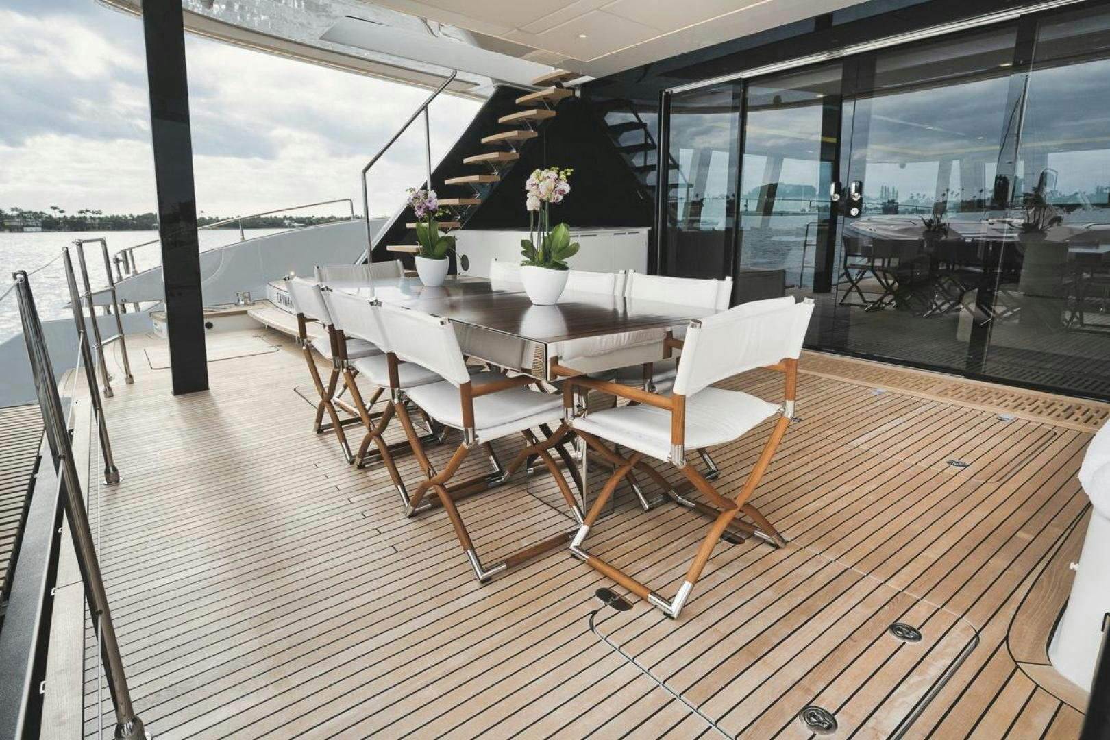 a room with a table and chairs aboard SANDY II Yacht for Sale