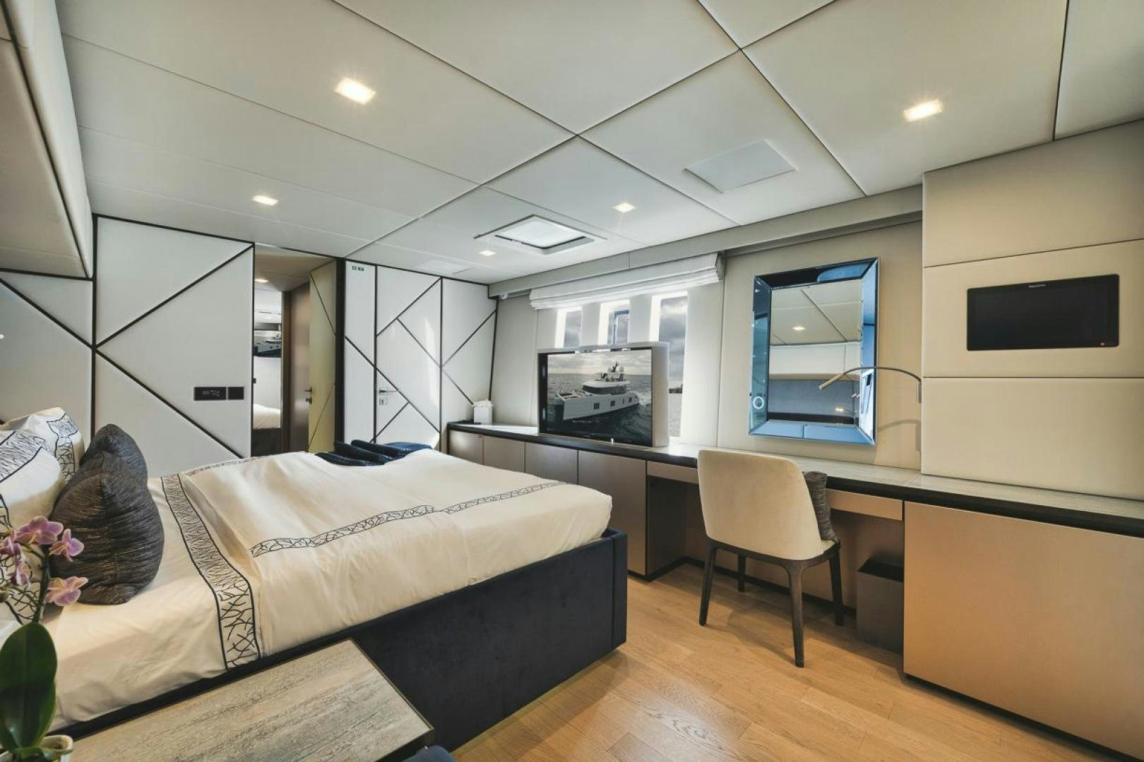 a bedroom with a bed and a desk aboard SANDY II Yacht for Sale