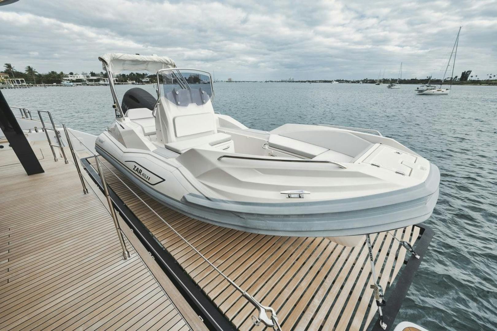 a white boat on a dock aboard SANDY II Yacht for Sale