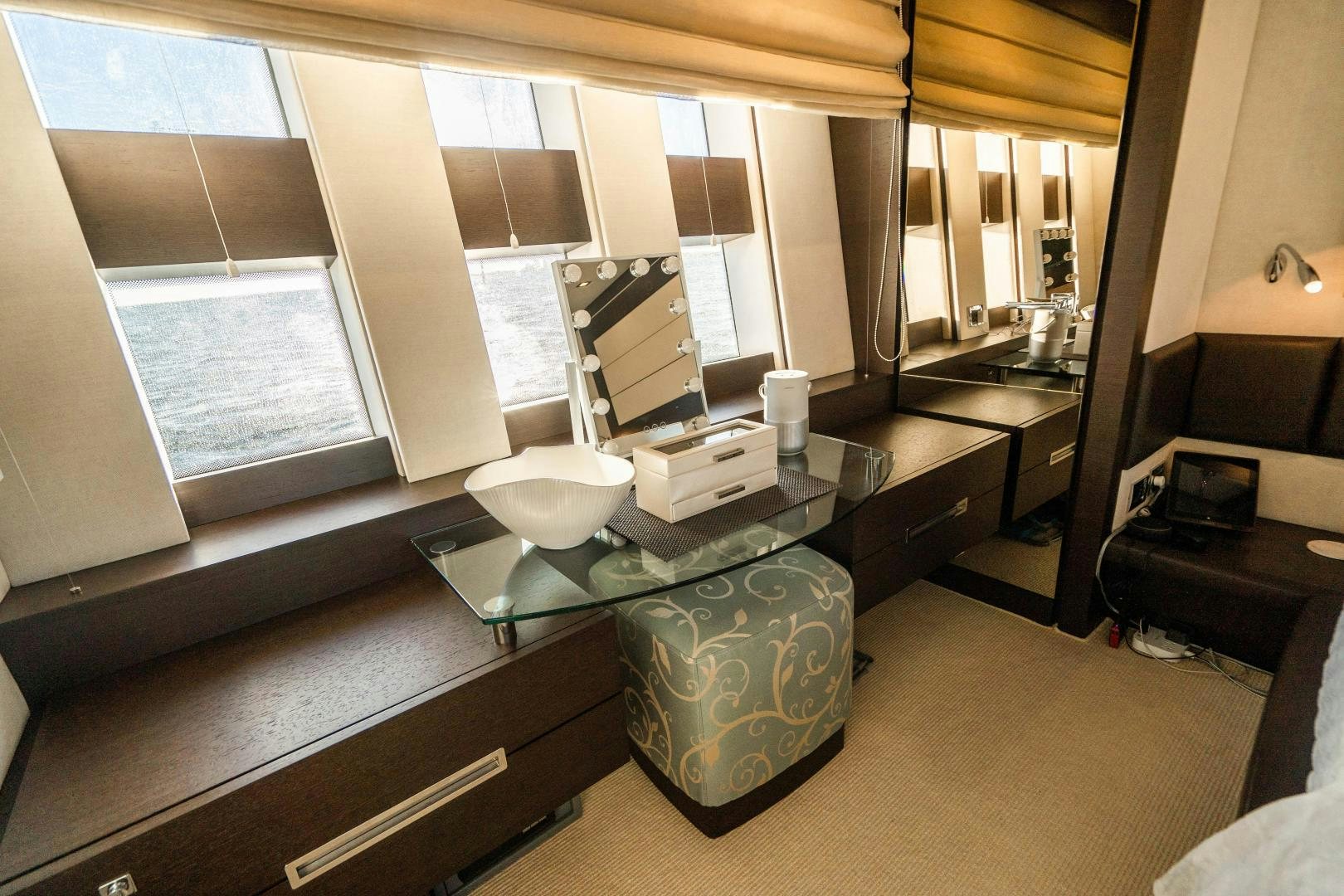 a room with a glass table and a large window aboard PLANE II SEA Yacht for Sale