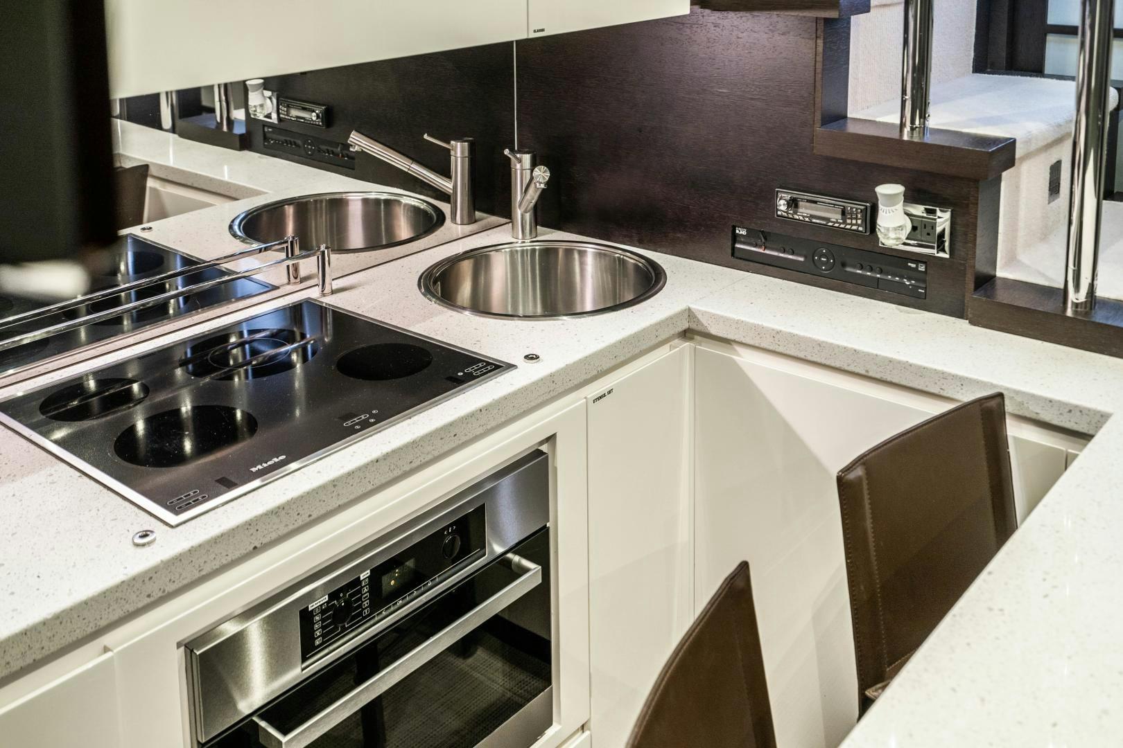 a kitchen with a sink and stove aboard PLANE II SEA Yacht for Sale