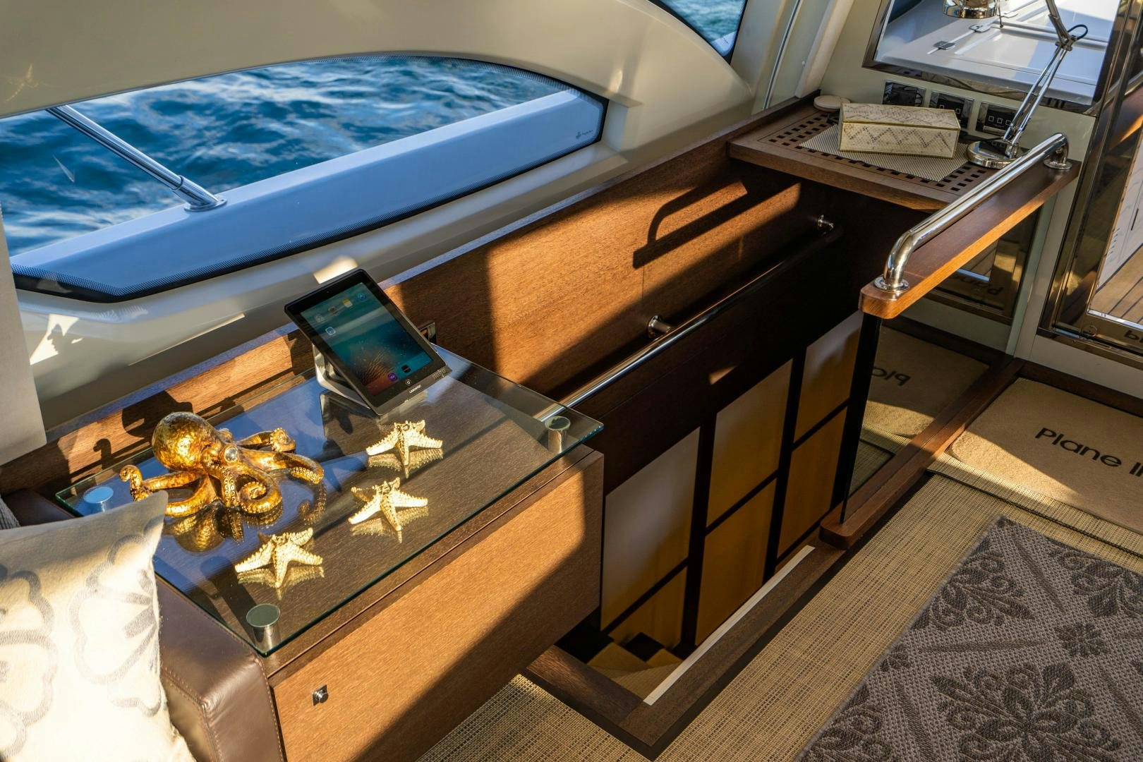 a desk with a laptop and a model airplane on it aboard PLANE II SEA Yacht for Sale