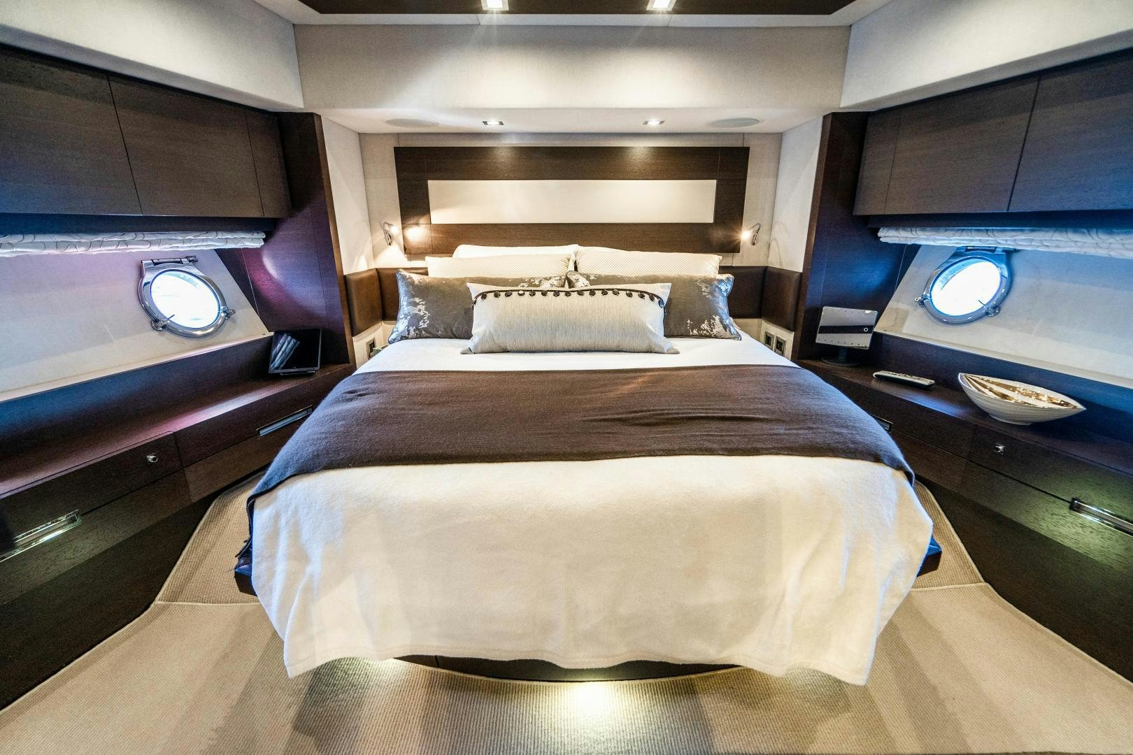 a bed with a purple headboard aboard PLANE II SEA Yacht for Sale