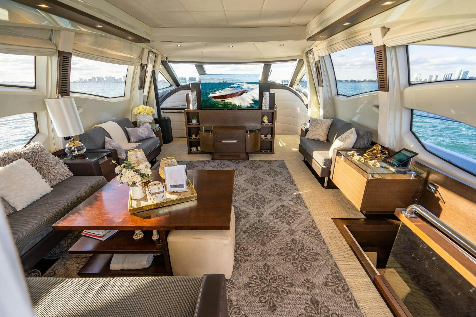 inside of a vehicle with a table and chairs and a bed aboard PLANE II SEA Yacht for Sale