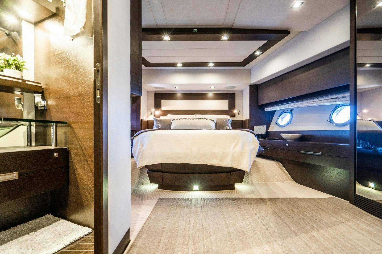 a room with a bed and a desk aboard PLANE II SEA Yacht for Sale