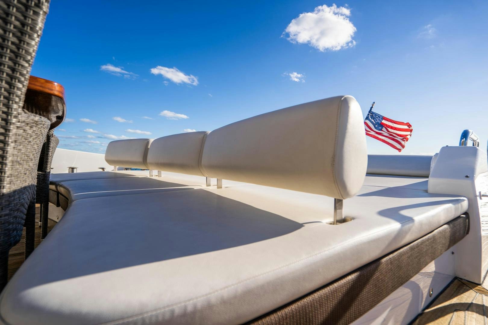a boat with a flag on the front aboard PLANE II SEA Yacht for Sale