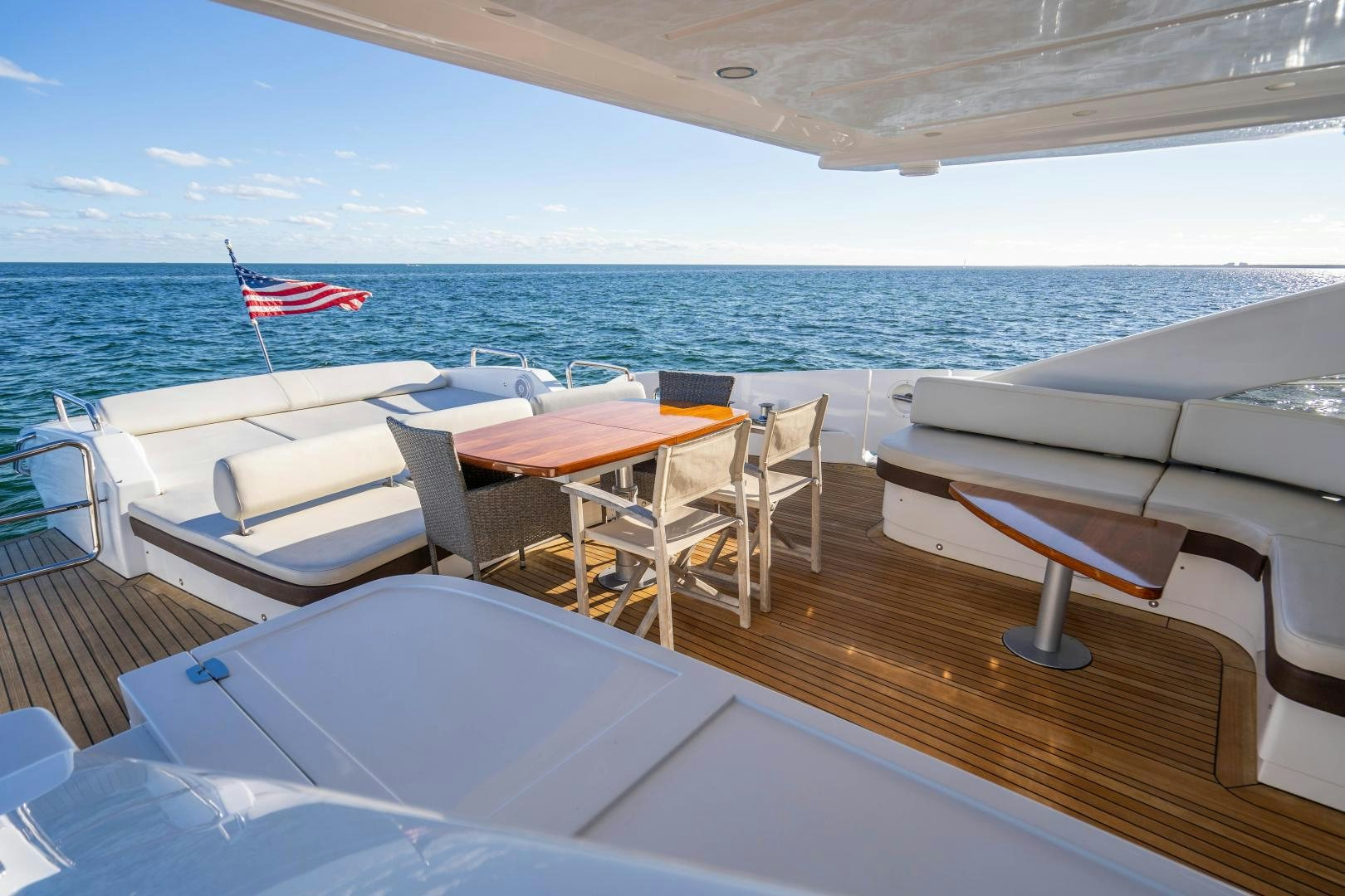 a deck with chairs and tables on it aboard PLANE II SEA Yacht for Sale