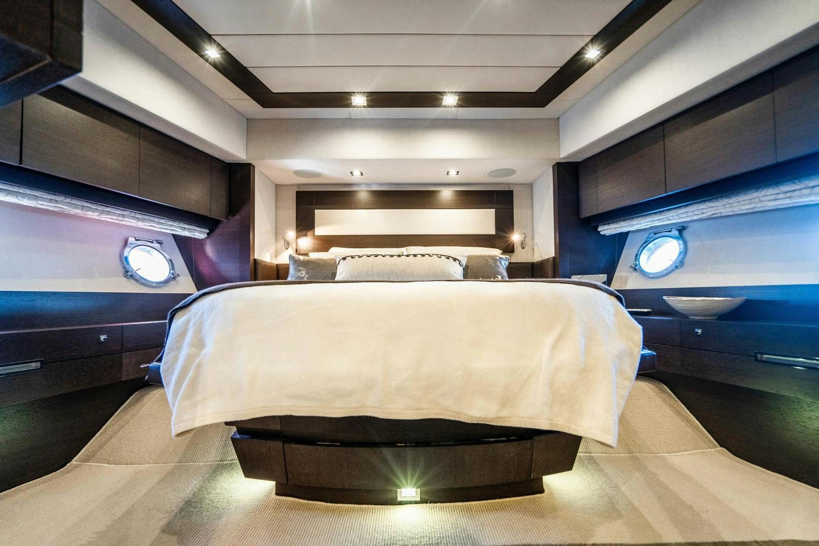 a room with a bed and a mirror aboard PLANE II SEA Yacht for Sale