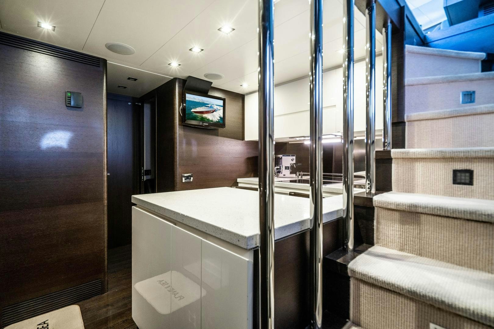 a room with a tv and a closet aboard PLANE II SEA Yacht for Sale