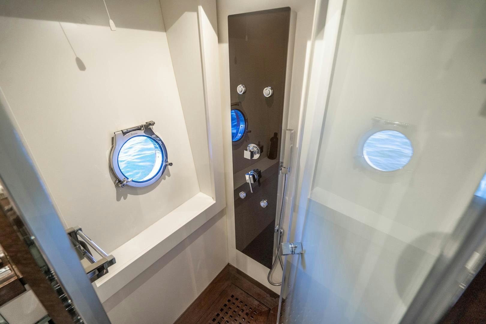 a bathroom with a glass door aboard PLANE II SEA Yacht for Sale