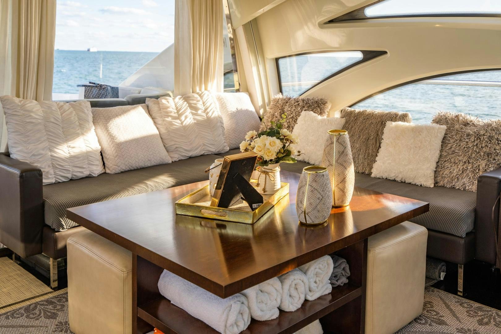 a living room with a large sofa and a coffee table aboard PLANE II SEA Yacht for Sale