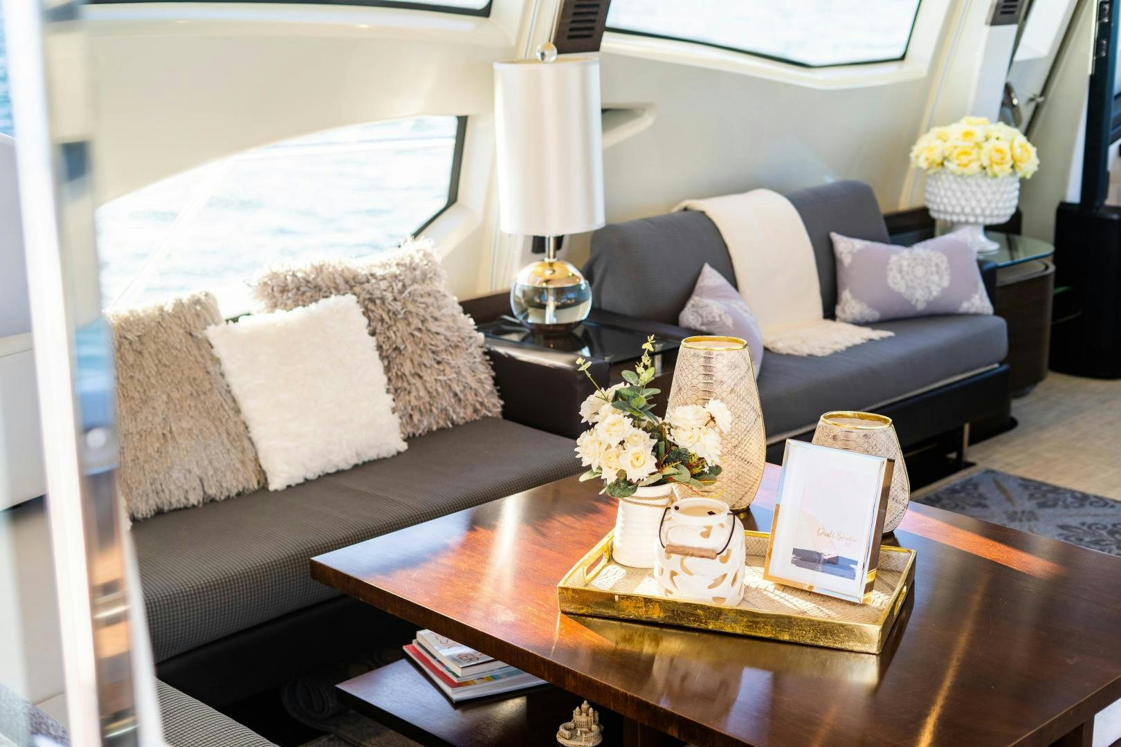 a living room with a couch and coffee table aboard PLANE II SEA Yacht for Sale