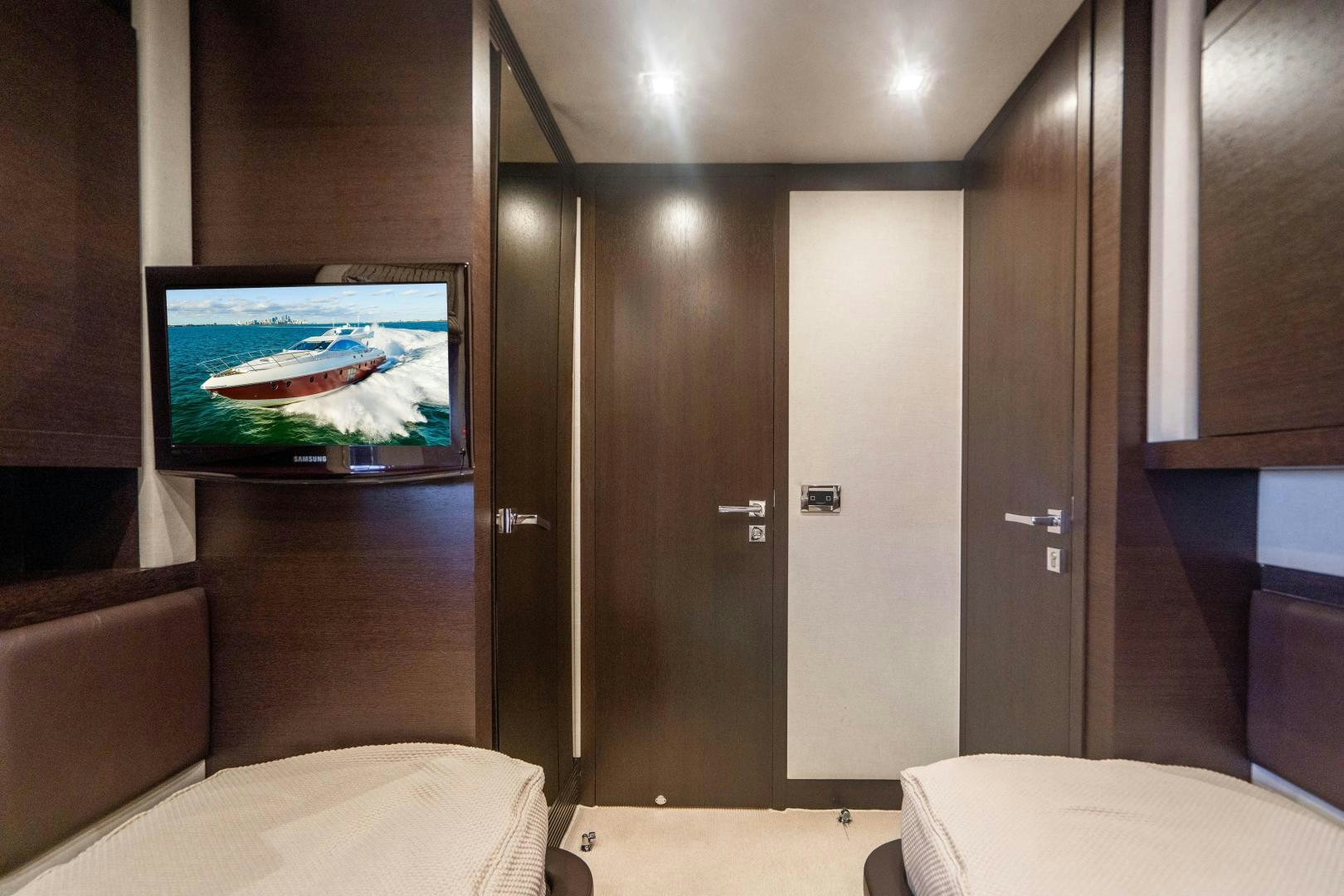 a room with a tv and a bed aboard PLANE II SEA Yacht for Sale