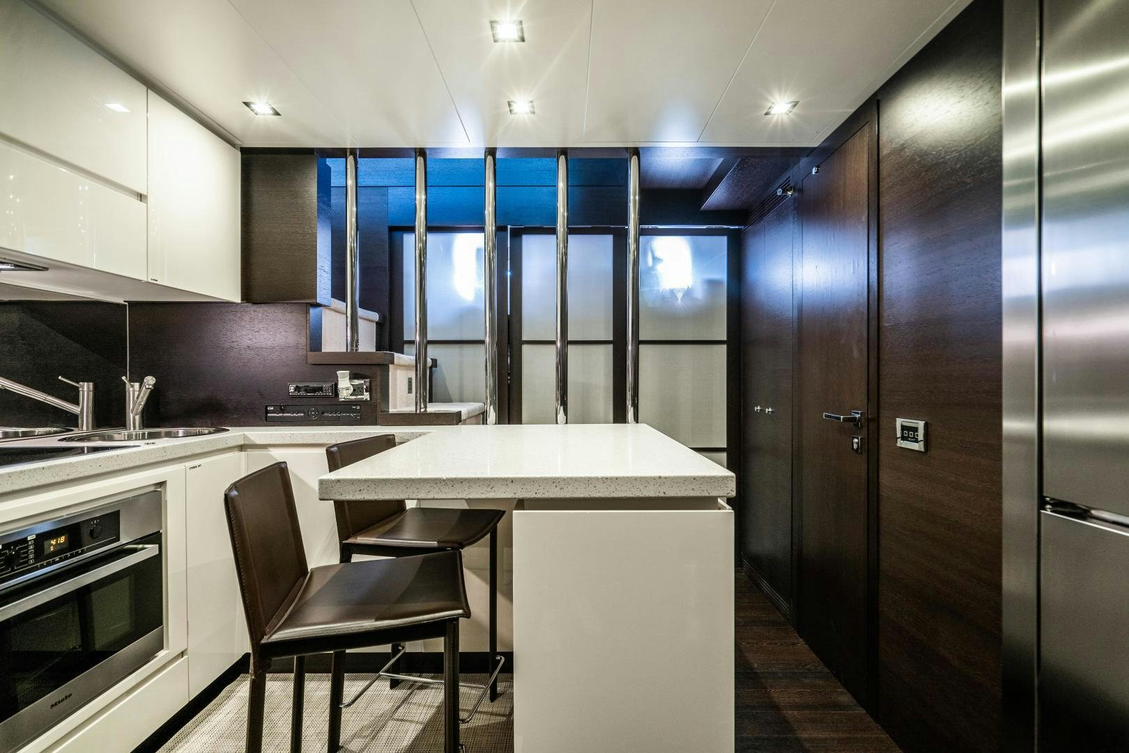 a kitchen with a table and chairs aboard PLANE II SEA Yacht for Sale