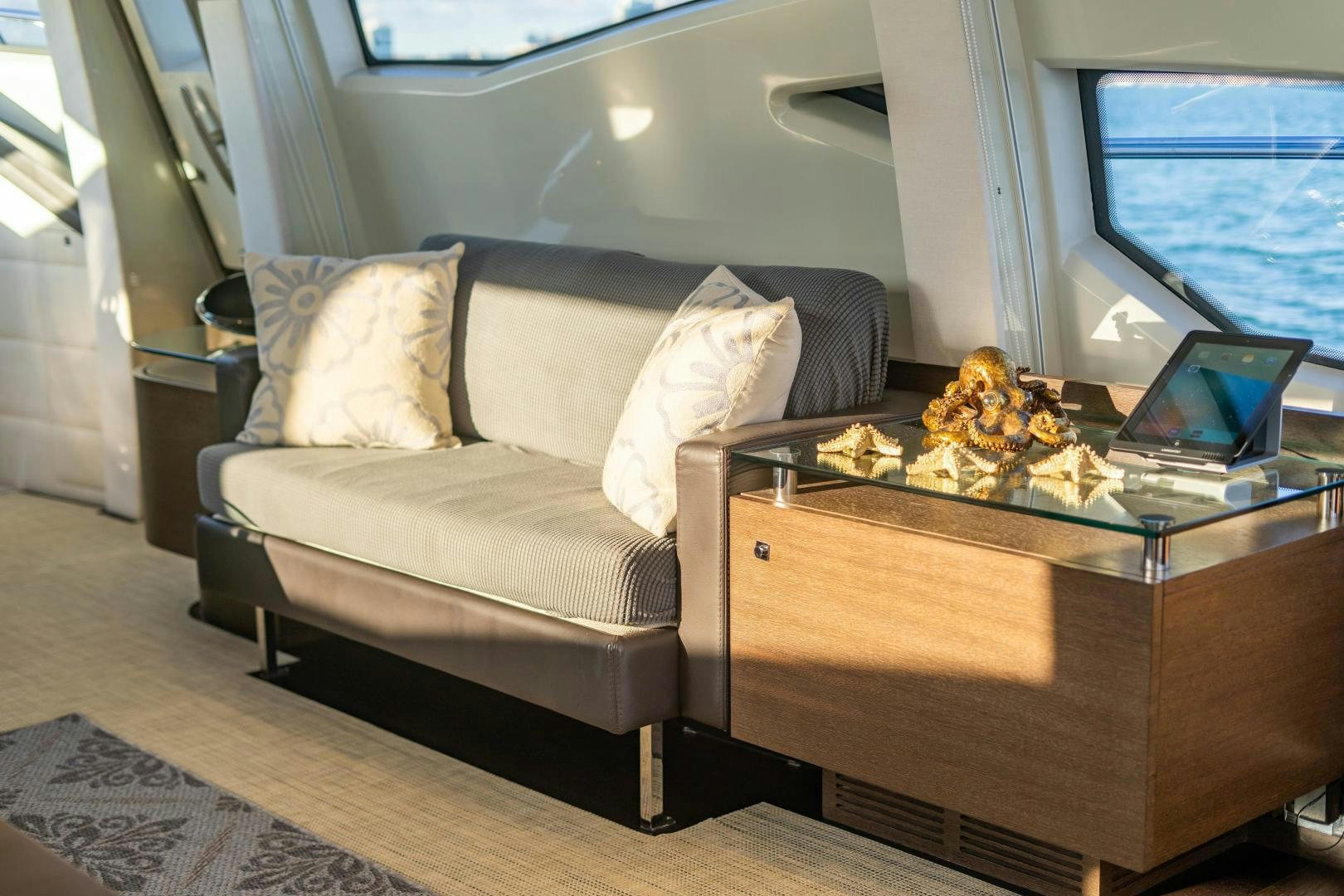 a living room with a couch and a coffee table aboard PLANE II SEA Yacht for Sale