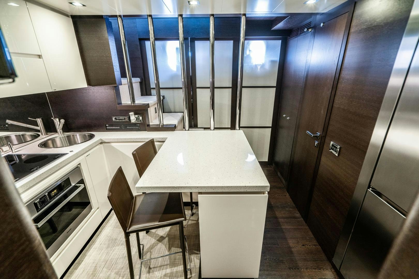 a kitchen with a table and chairs aboard PLANE II SEA Yacht for Sale