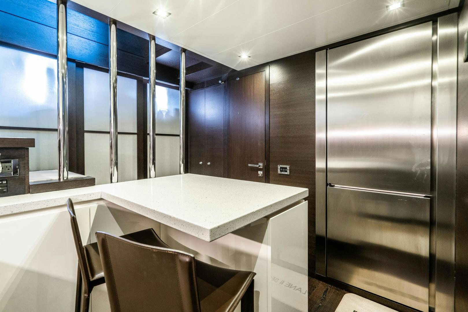 a large kitchen with a large glass wall aboard PLANE II SEA Yacht for Sale