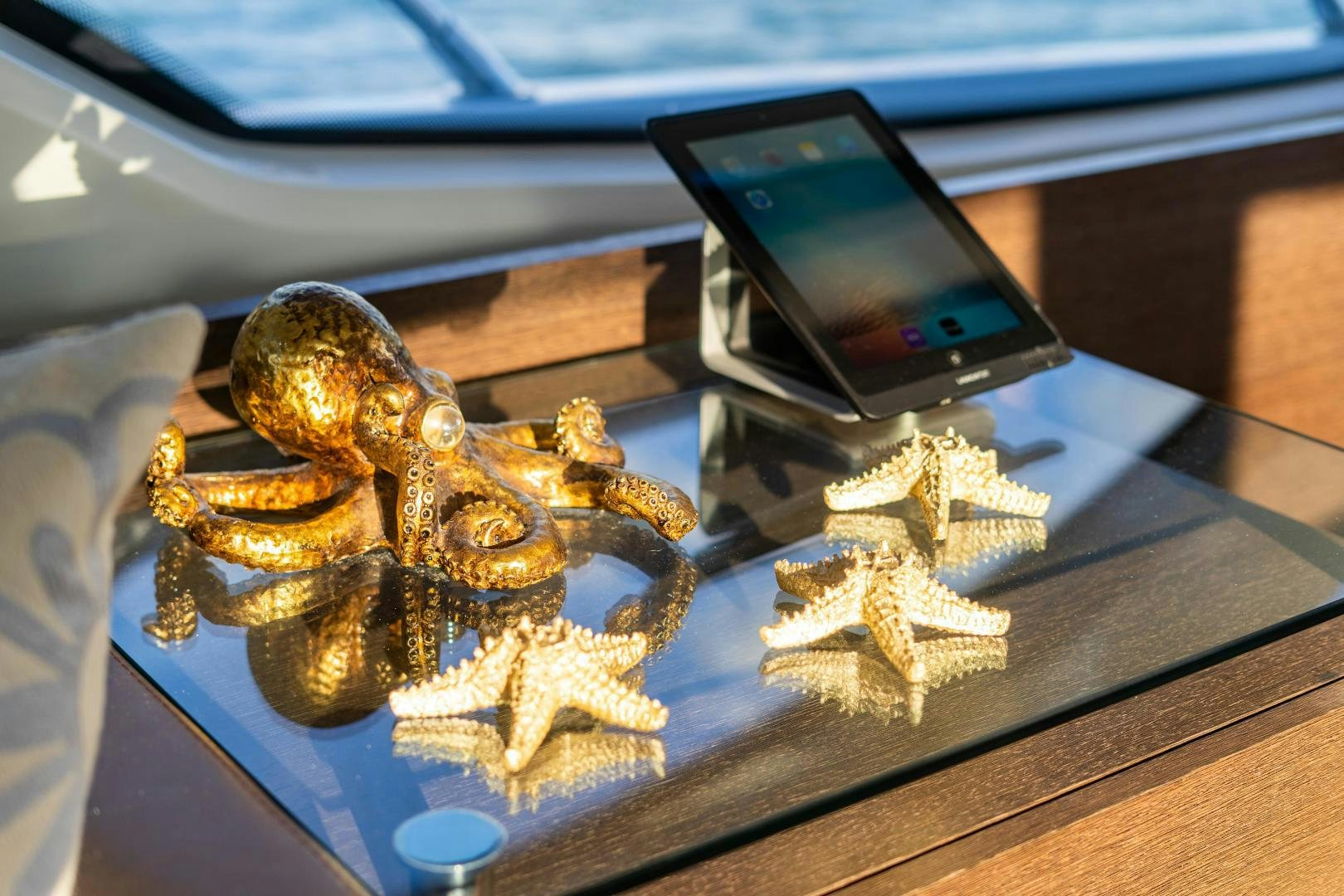 a gold and silver sculpture on a table aboard PLANE II SEA Yacht for Sale