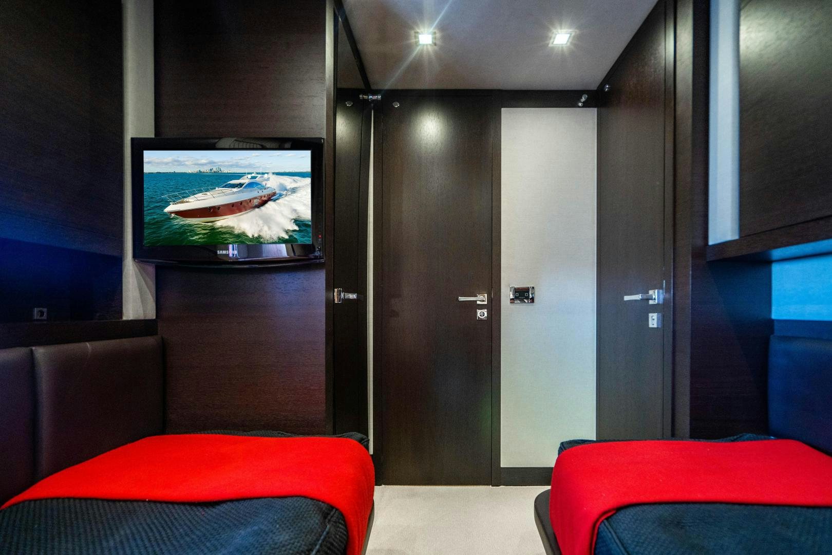 a room with a tv and a couch aboard PLANE II SEA Yacht for Sale