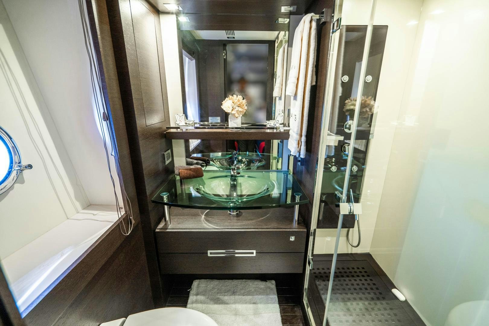 a bathroom with a glass shower aboard PLANE II SEA Yacht for Sale
