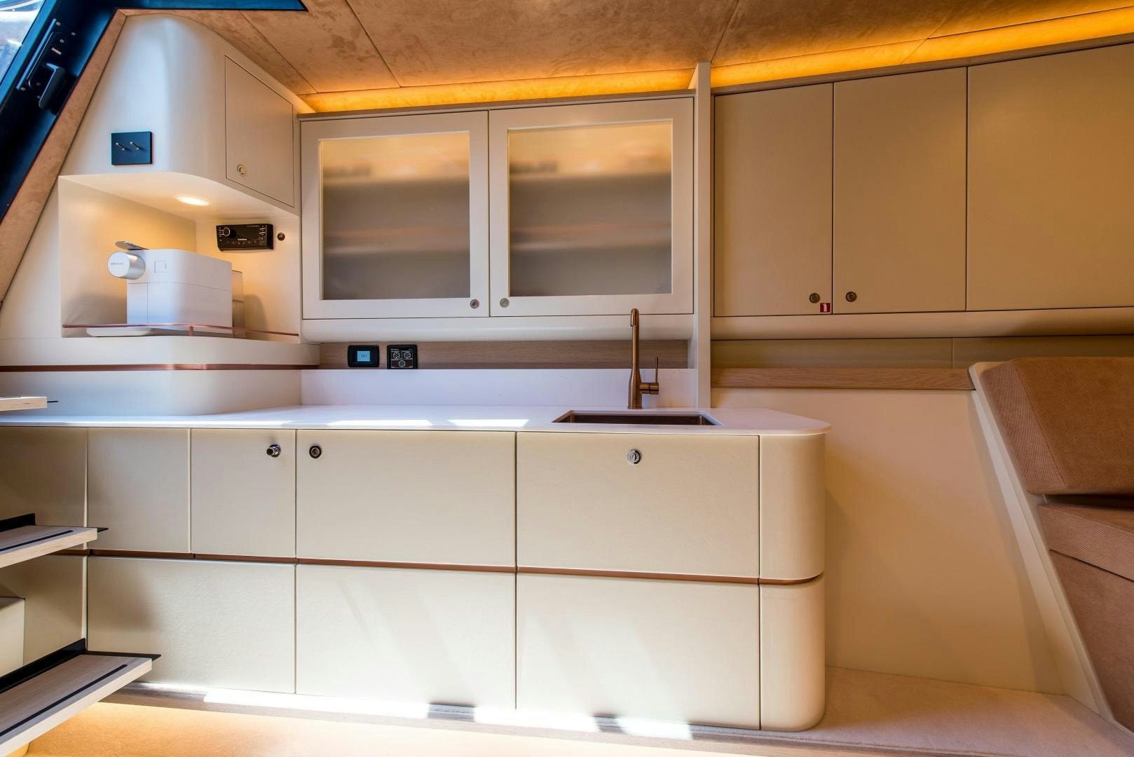 a kitchen with white cabinets aboard BENEAU WATERDREAM 52 Yacht for Sale