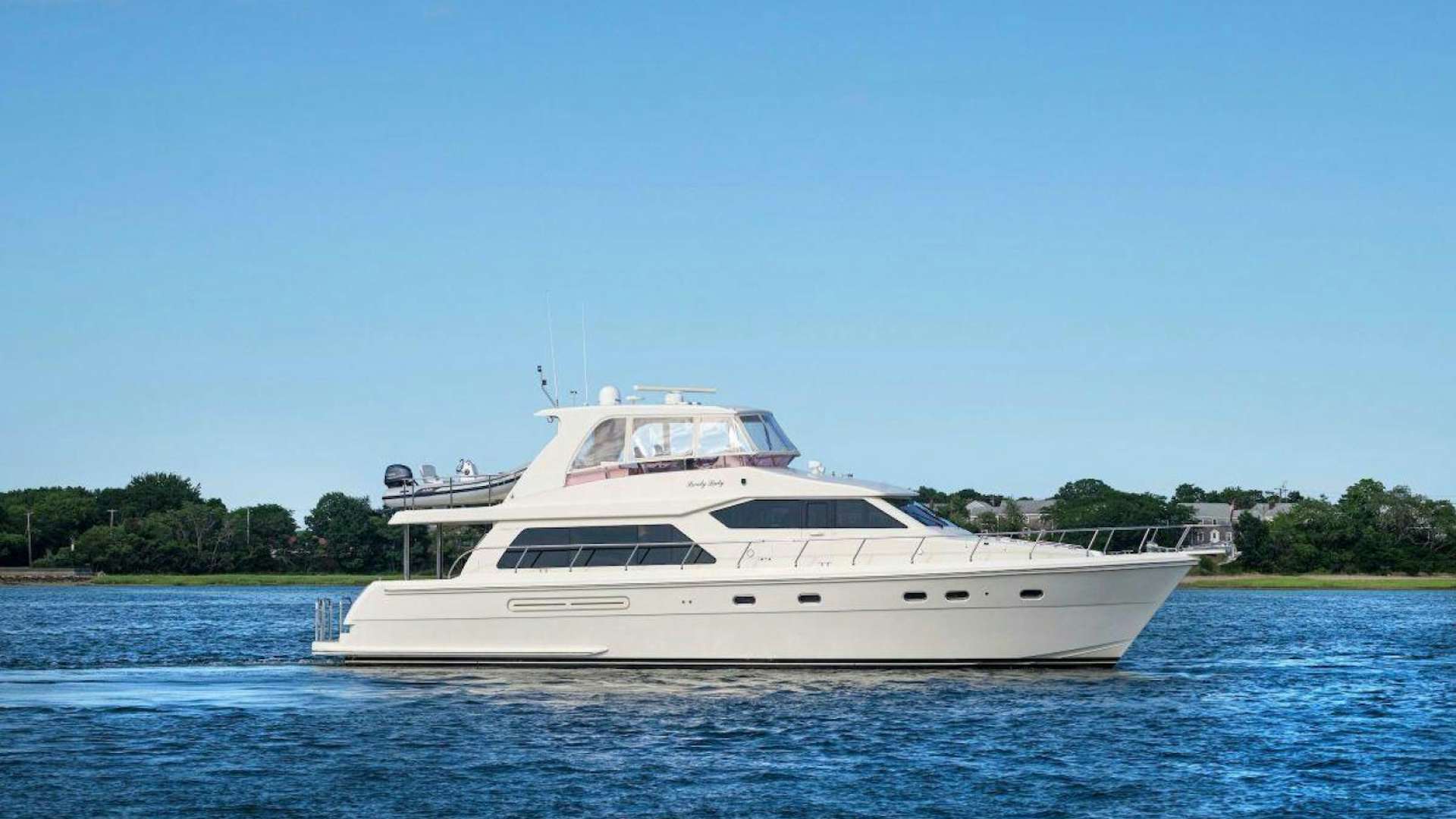 a white yacht on the water aboard HIGHFALUTIN Yacht for Sale