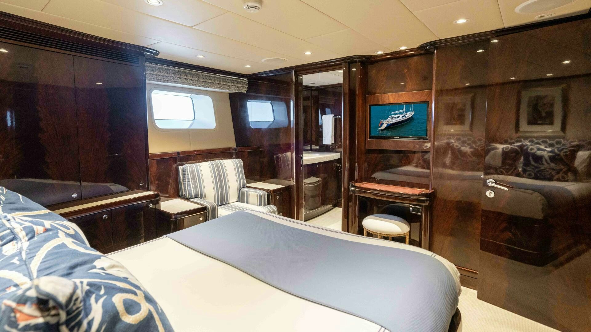 a room with a bed and a tv on the wall aboard ANEMOI Yacht for Sale