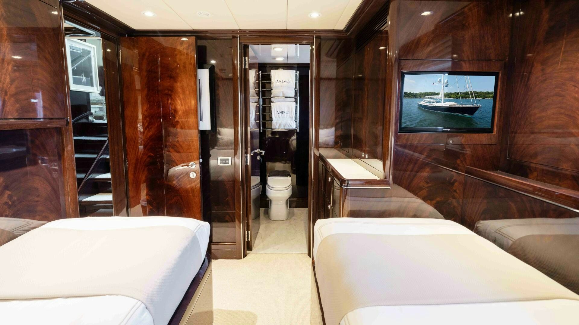 a room with a bed and a mirror aboard ANEMOI Yacht for Sale