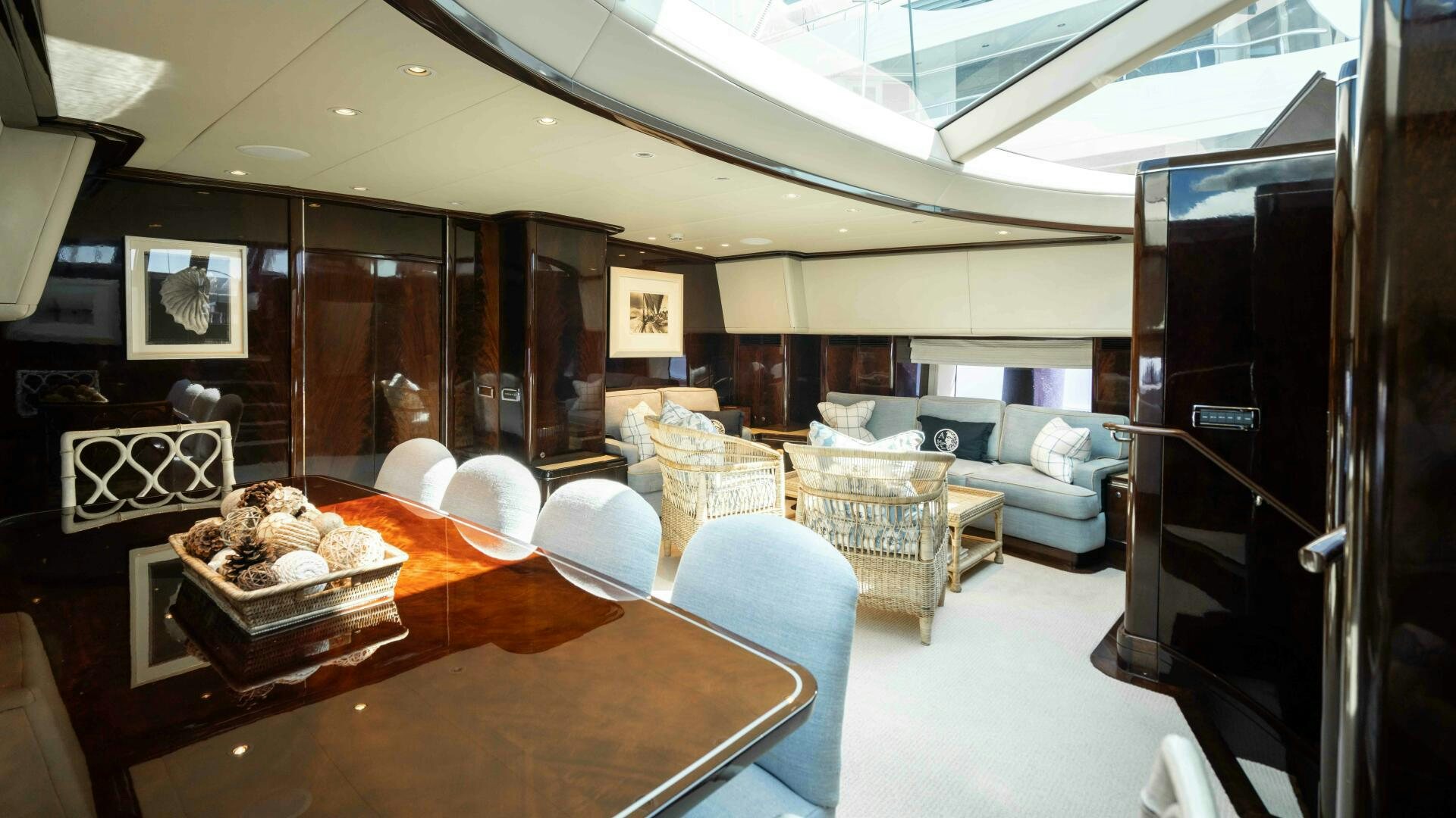 a room with a table chairs and a couch aboard ANEMOI Yacht for Sale