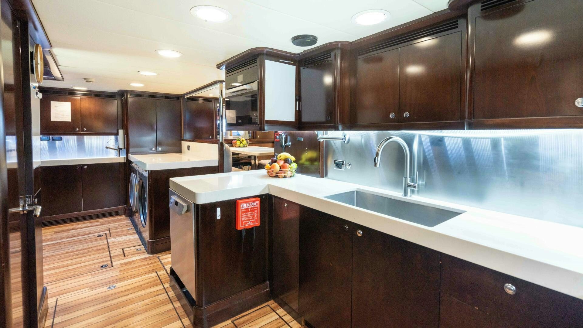a kitchen with wooden cabinets aboard ANEMOI Yacht for Sale