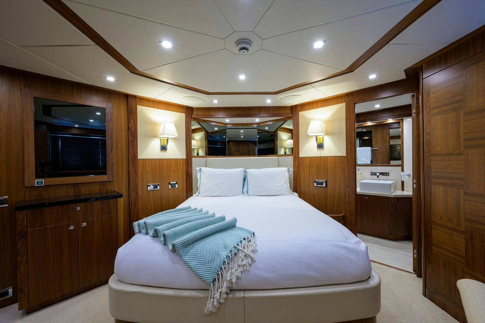 a bedroom with a bed and a wood cabinet aboard SULLIVAN'S ISLAND Yacht for Sale
