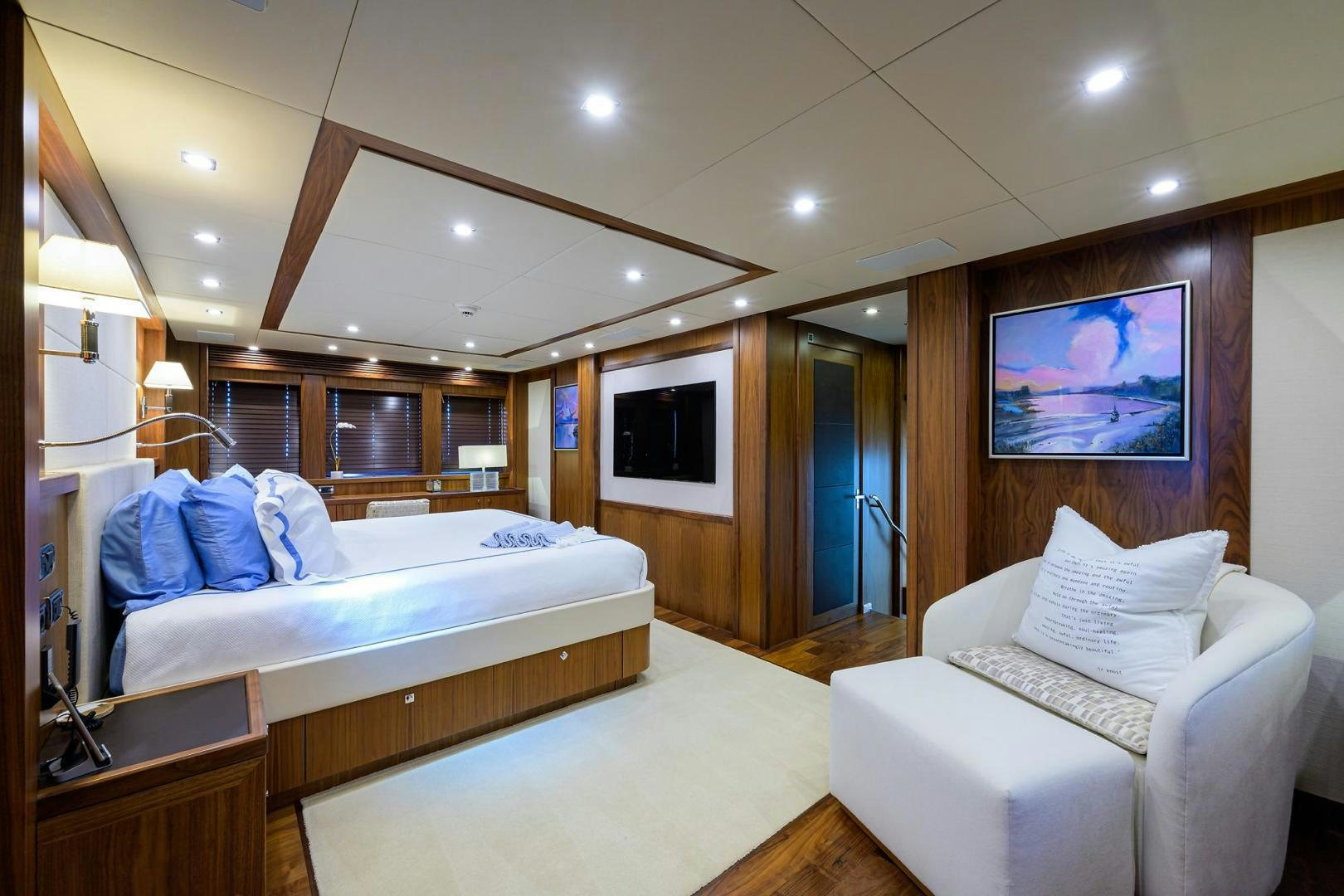 a bedroom with a bed and a chair aboard SULLIVAN'S ISLAND Yacht for Sale