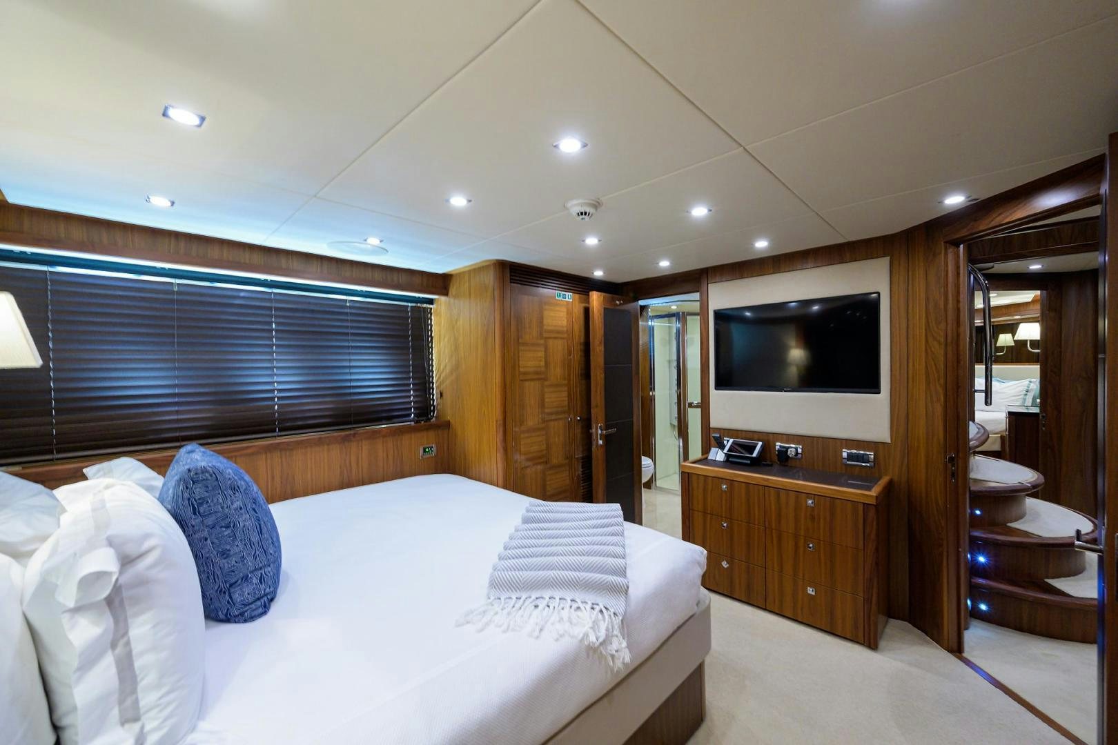a bedroom with a bed and a television aboard SULLIVAN'S ISLAND Yacht for Sale