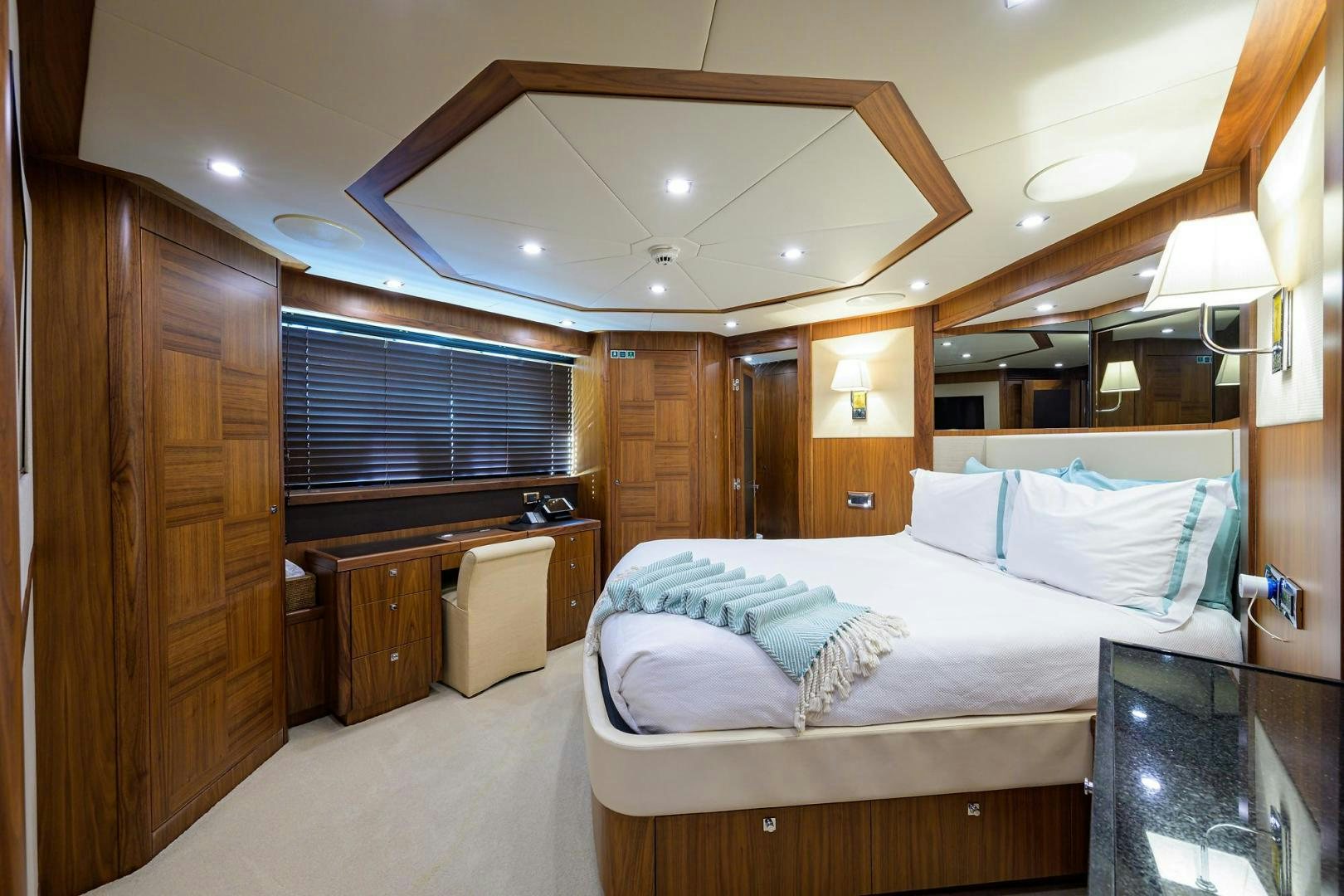 a bedroom with a bed and a desk aboard SULLIVAN'S ISLAND Yacht for Sale