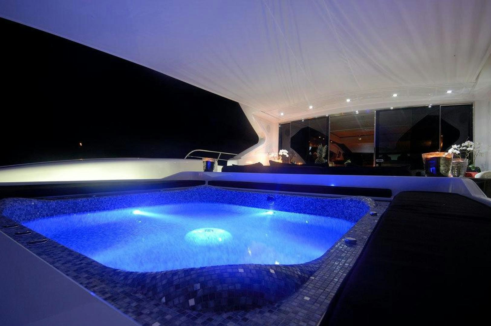 a pool with a blue lit up pool aboard ARES Yacht for Sale