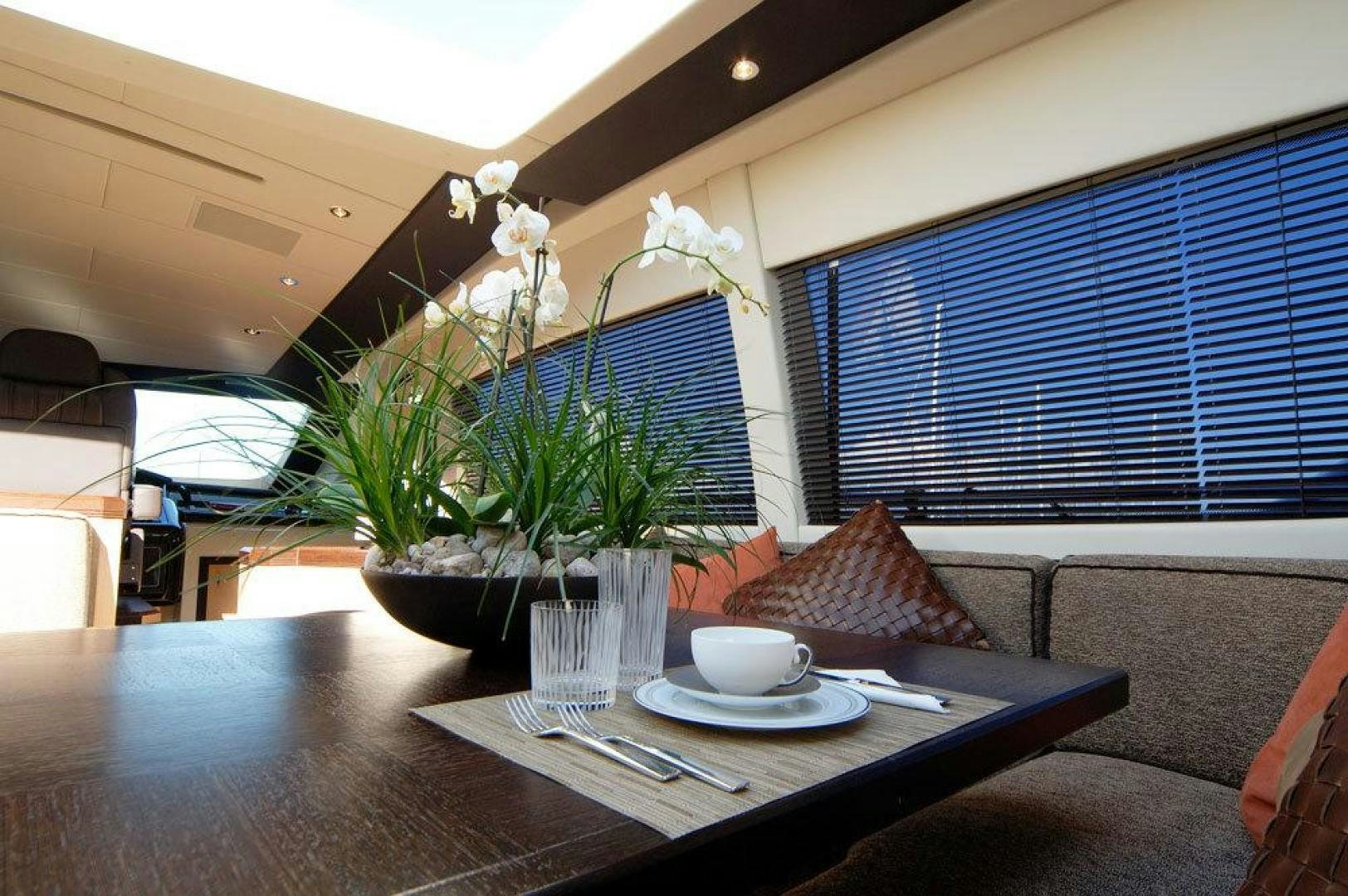 a table with a plate of flowers and a cup of coffee aboard ARES Yacht for Sale