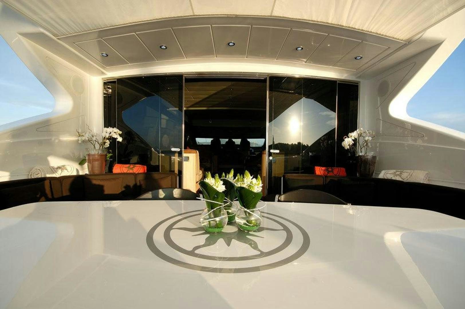 a room with a table and vases with flowers aboard ARES Yacht for Sale