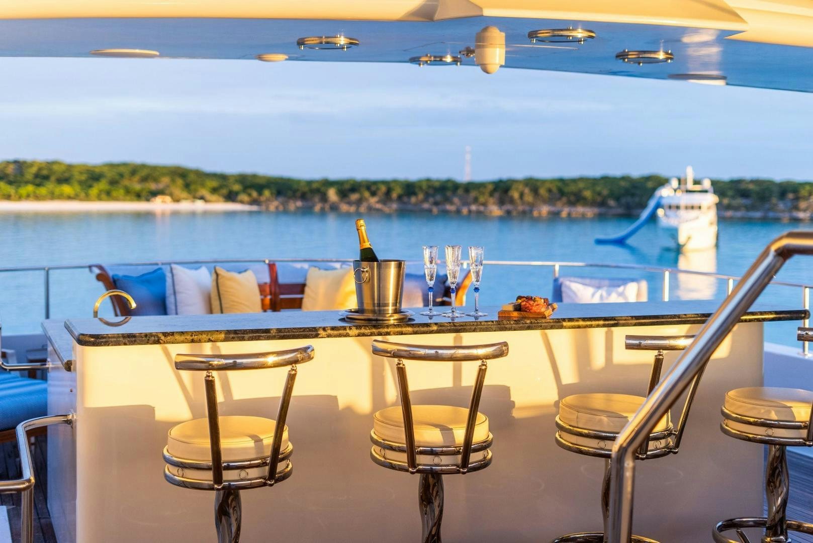a table with chairs and a view of the water aboard GRADE I Yacht for Sale