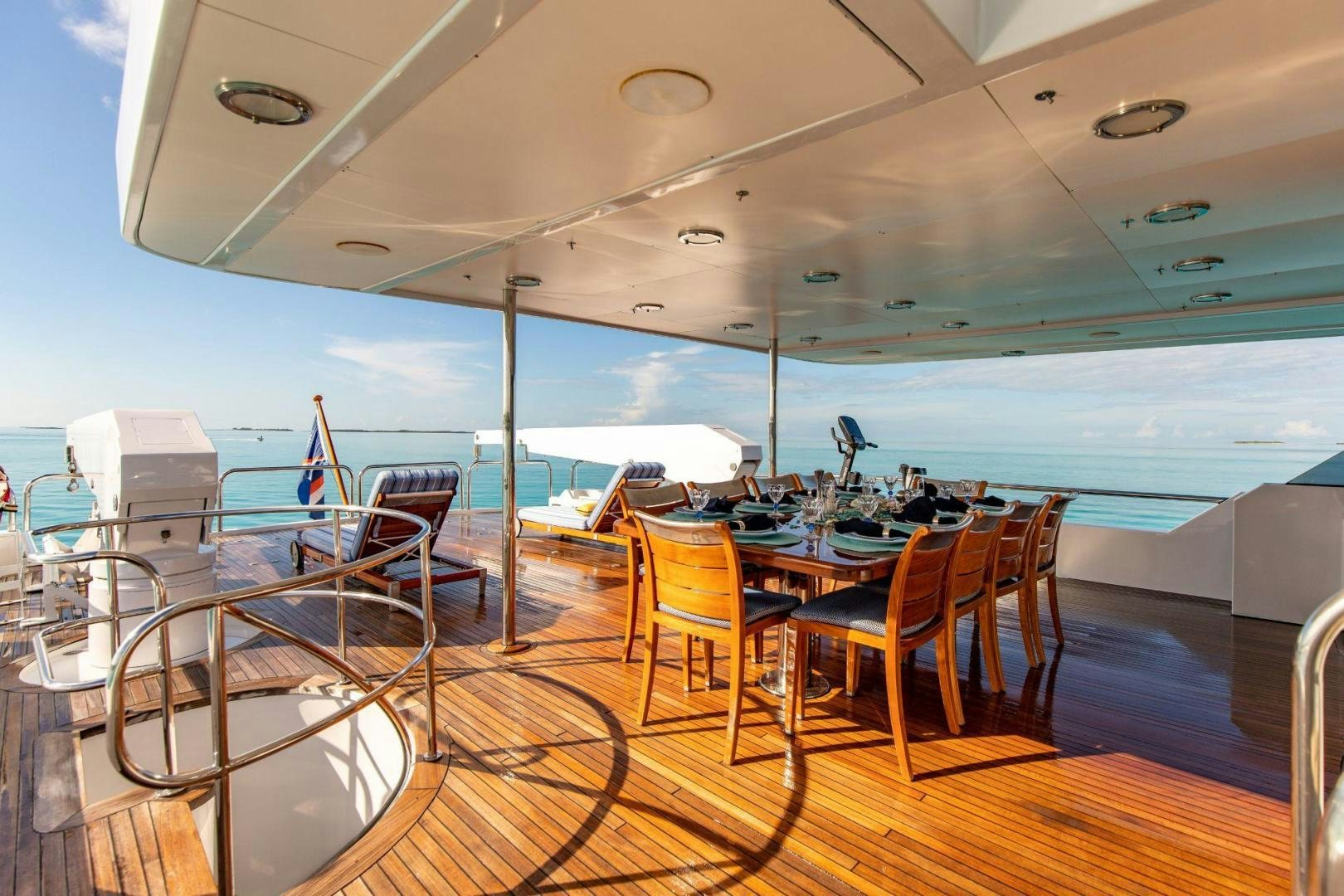 a large room with a table and chairs aboard GRADE I Yacht for Sale