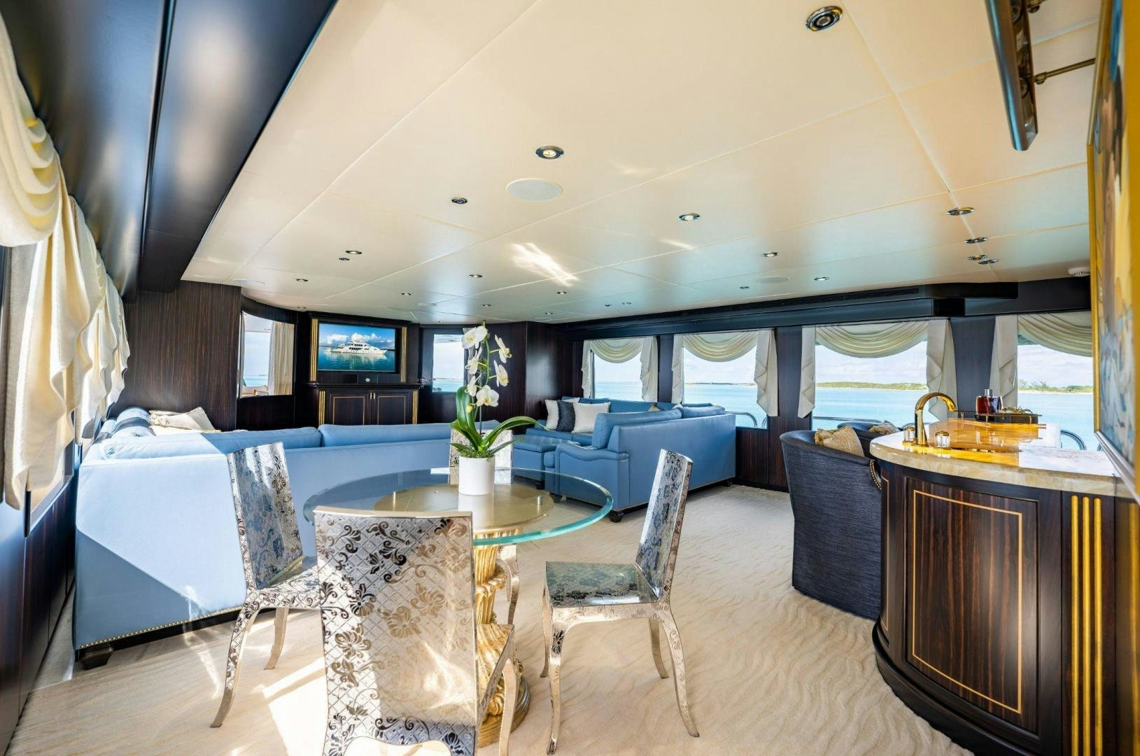 a large living room with a table and chairs aboard GRADE I Yacht for Sale