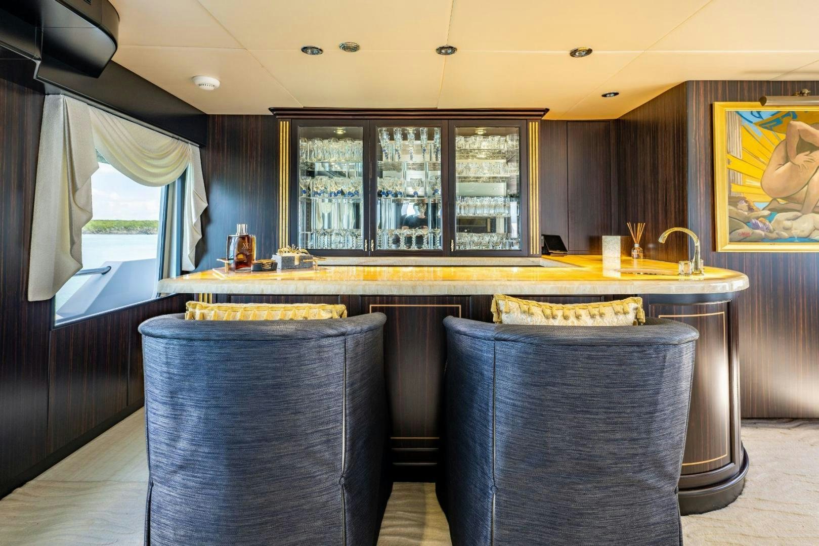 a kitchen with a blue chair aboard GRADE I Yacht for Sale