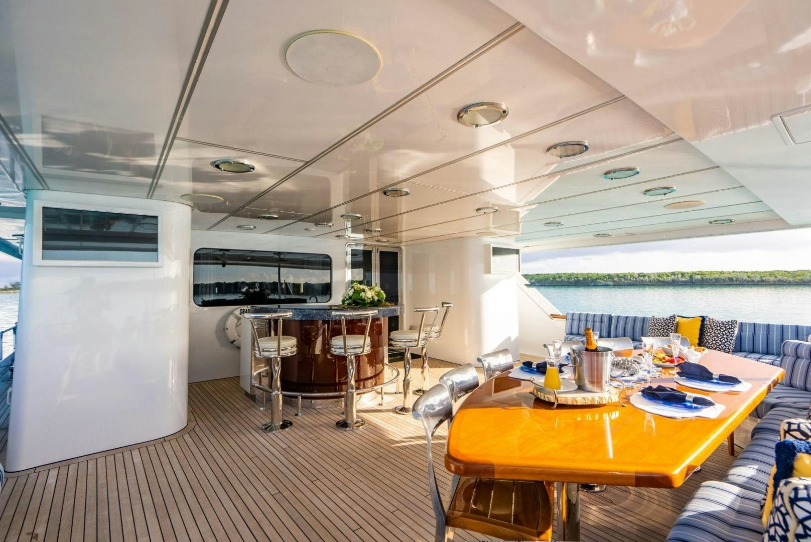 a room with tables and chairs aboard GRADE I Yacht for Sale