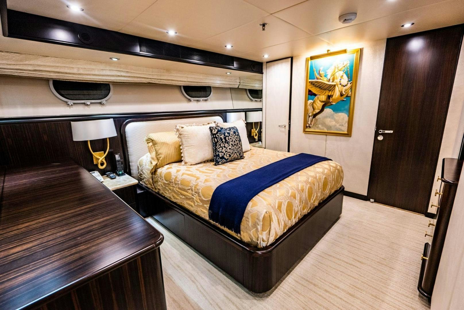 a bedroom with a bed and a desk aboard GRADE I Yacht for Sale